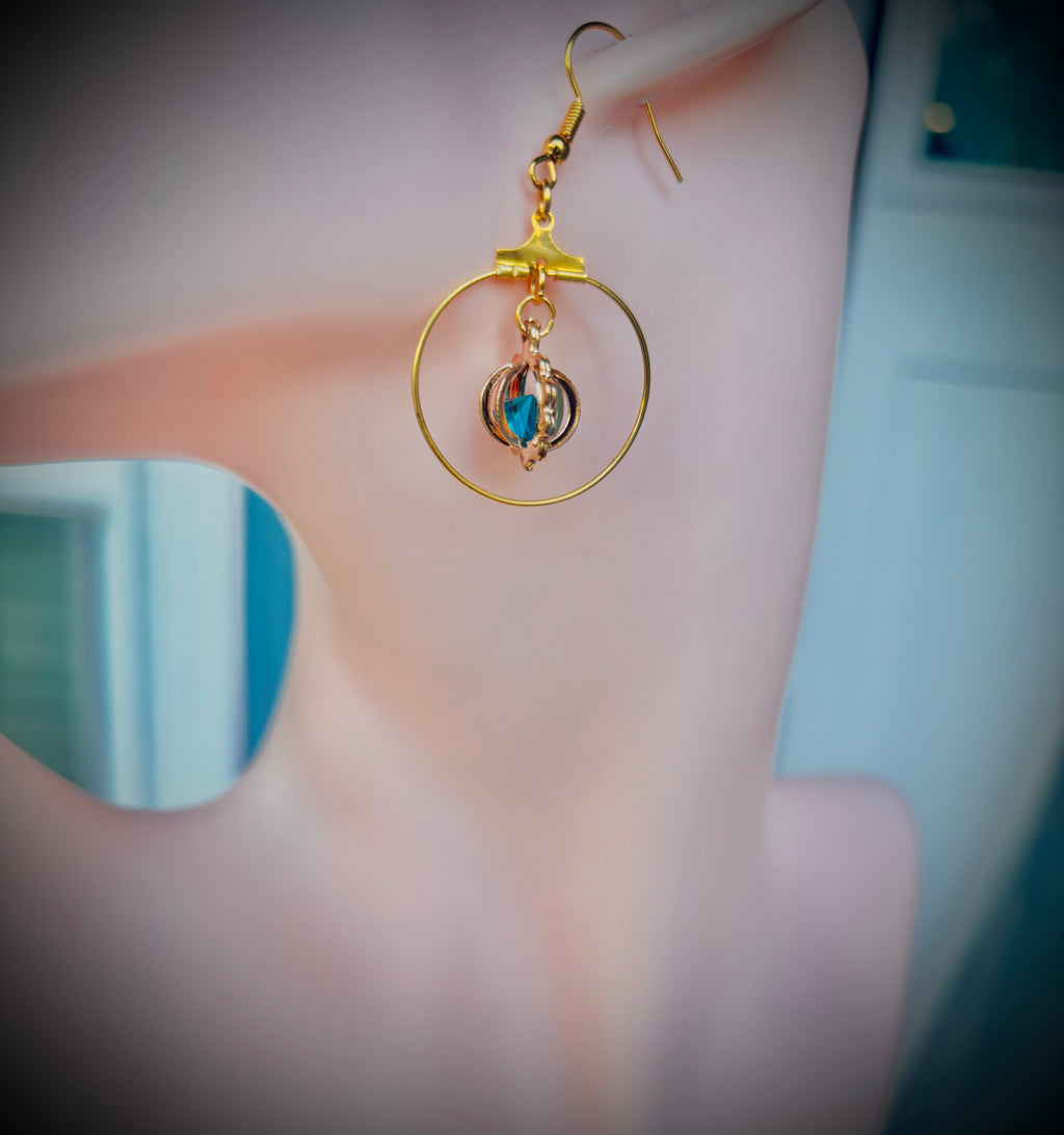 Gold tone hoop earrings with blue gem