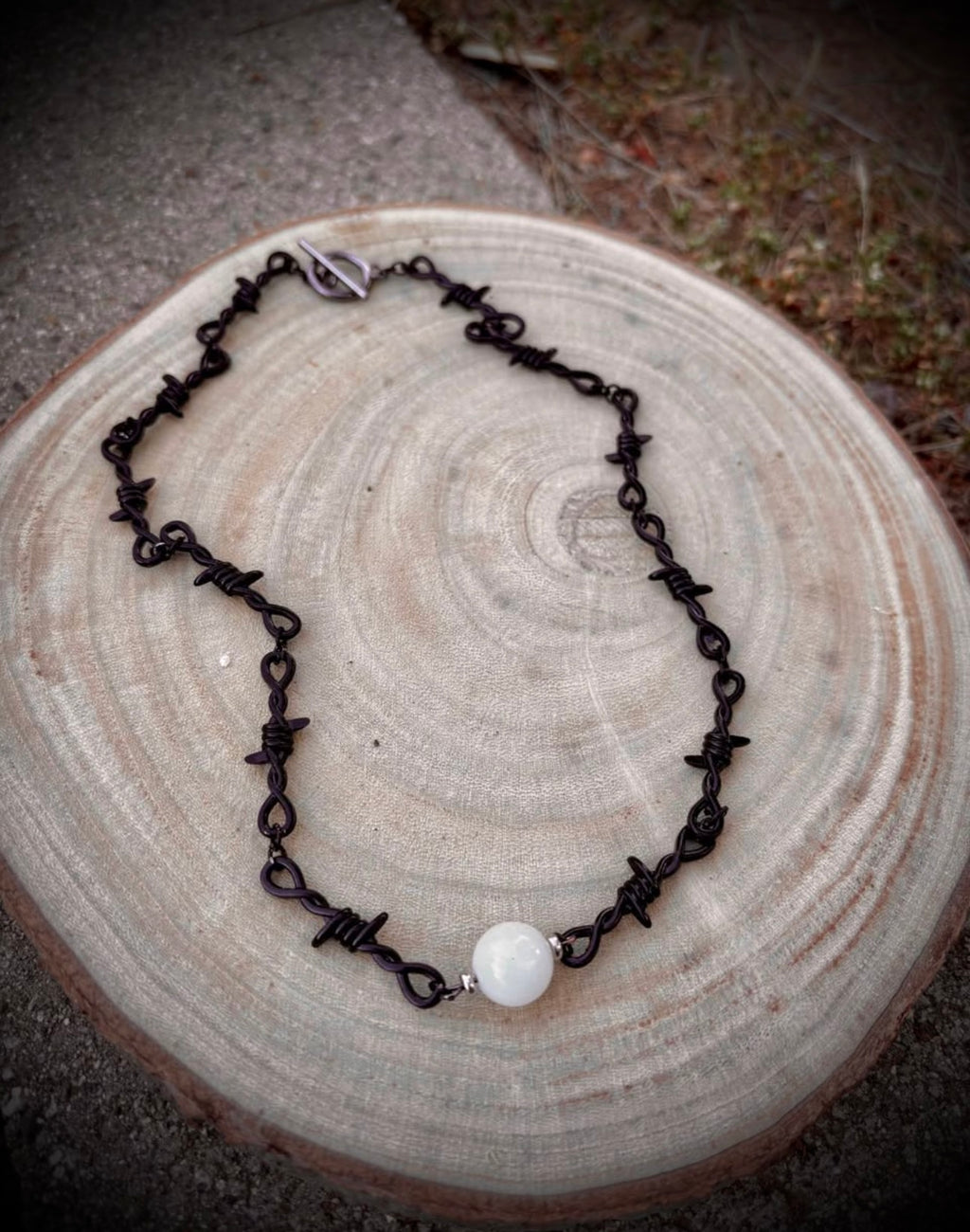 Black barbed wire necklace with glow stone