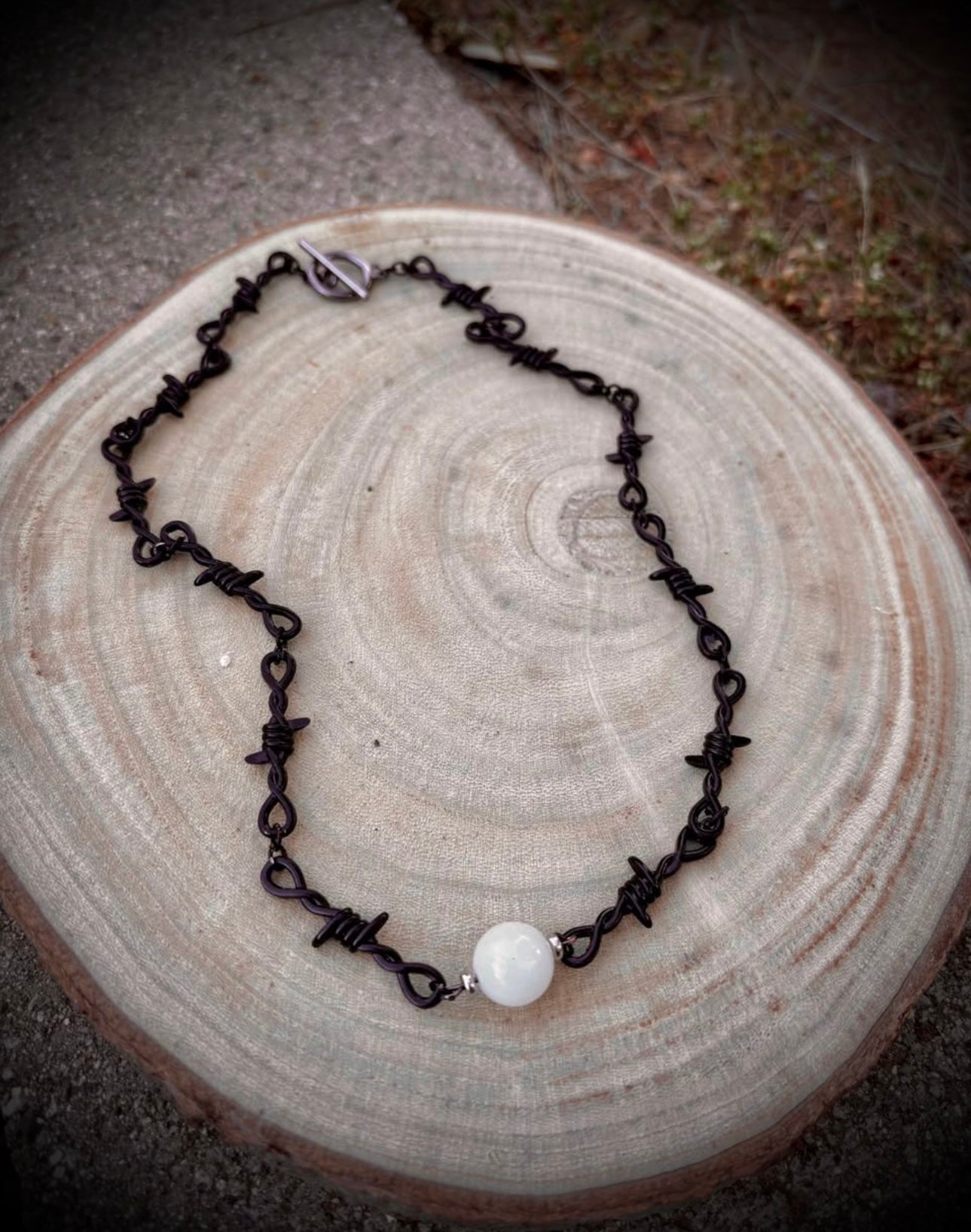 Black barbed wire necklace with glow stone
